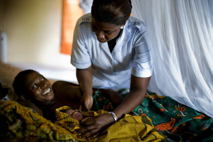Midwife Elizabeth Mpunga talks to a new mother at the health centre in Rtamba, Tanzania